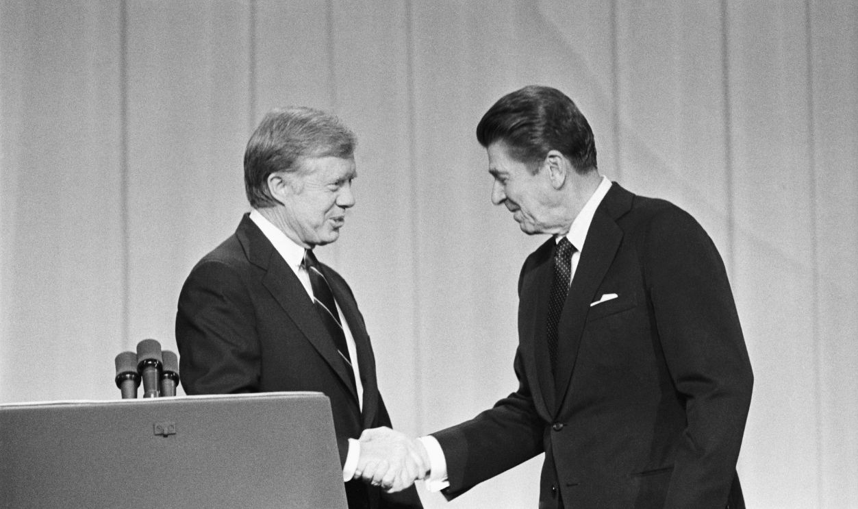 President Jimmy Carter and his Republican challenger, Ronald Reagan, shake hands as they greet one another before their debate on the stage of the Music Hall in Cleveland, Ohio 10/28/1980
