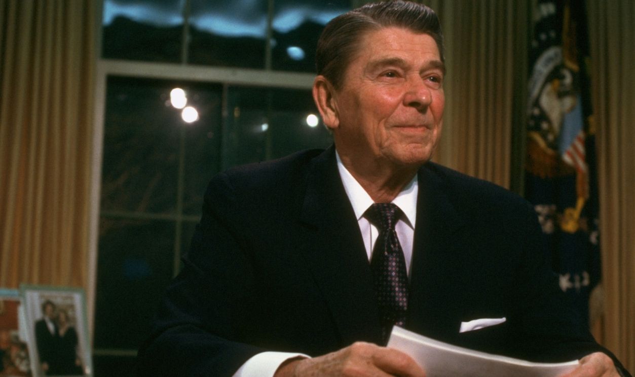 President Ronald Reagan sitting at desk in the Oval Office of the White House after adressing the nation, re Iran-Contra affair.