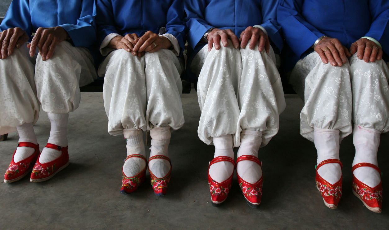 Members of the Bound Feet Women Dancing Team, pose for pictures during dancing practice at Liuyi Village on April 2, 2007 in Tonghai County of Yunnan Province, China. Liuyi Village is known as the