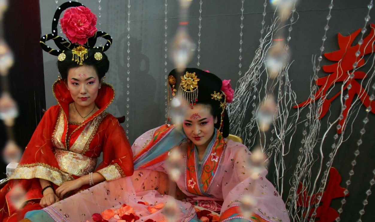 Two saleswomen dressed as imperial concubines, promote a spa equipped building during the Spring Housing Expo in the Shaanxi International Exhibition Center on March 28, 2008 in Xian of Shaanxi Province, China. According to figures released by the National Development and Reform Commission on January 31, housing prices continued to soar in China with the average housing price in China's 70 large- and medium-sized cities rising 10.2 percent in the fourth quarter of 2007, comparing the same period of 2006.