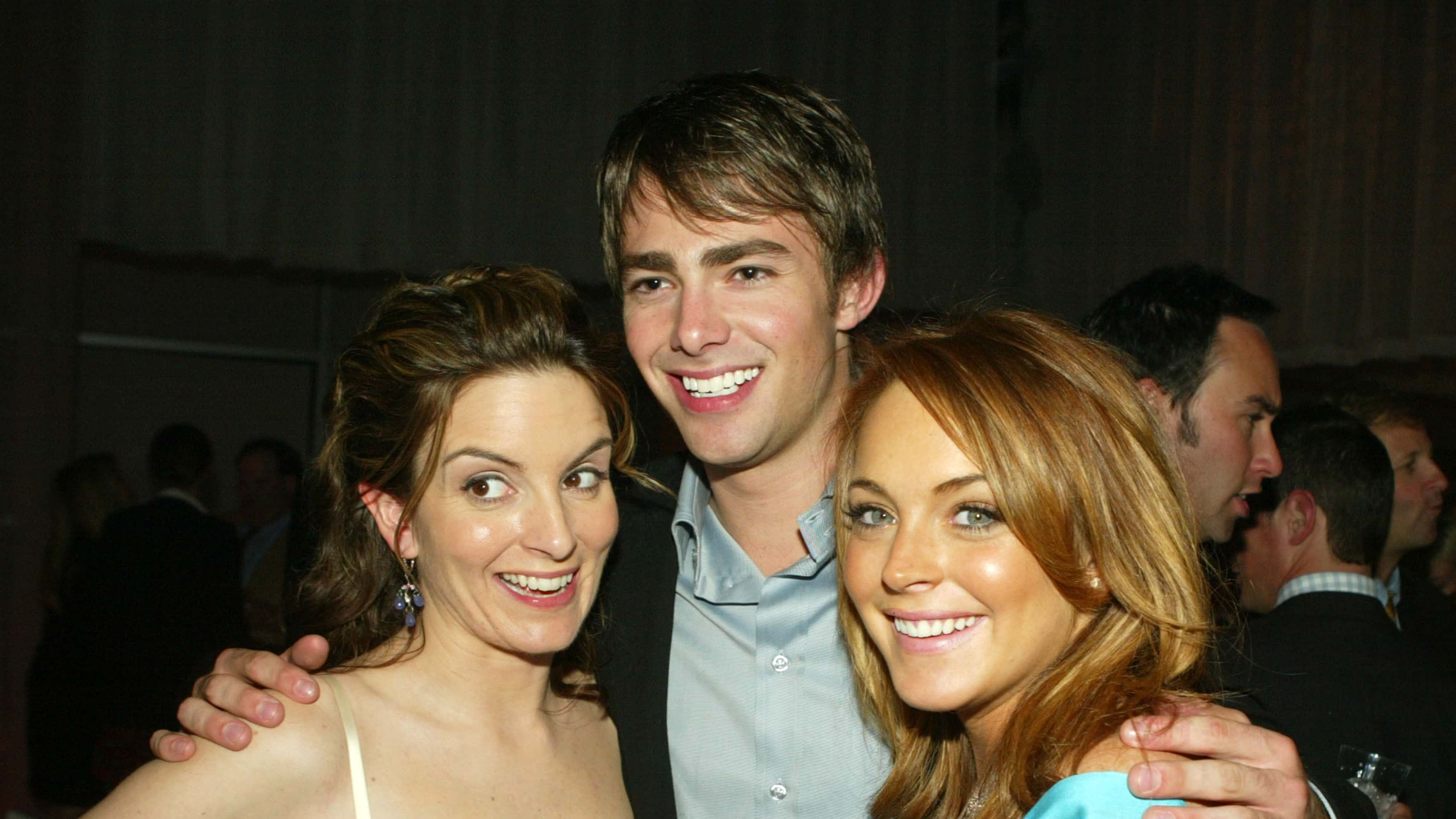 LOS ANGELES - APRIL 19: Actress Tina Fey (L) poses with fellow cast members Jonathan Bennett and Lindsay Lohan at the after-party for Paramount's "Mean Girls" at the Cinerama Dome Theater on April 19, 2004 in Los Angeles, California.