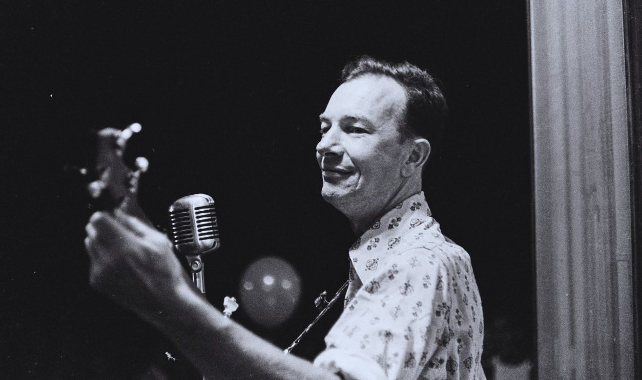 Gettyimages - 1396550299, Pete Seeger Performs At The World Peace Fair American folk musician Pete Seeger (1919 - 2014) plays an acoustic guitar as he performs onstage during the World Peace Fair, Fairless Hills, Pennsylvania, September 1960.
