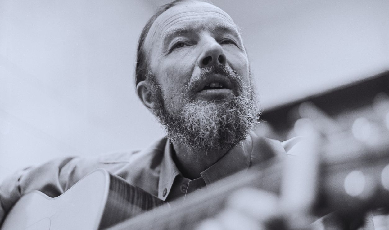 Gettyimages - 2213542032, Pete Seeger Warms Up Folk singer Pete Seeger warms backstage up before a United Way Benefit in the Poughkeepsie, NY High School in 1969.
