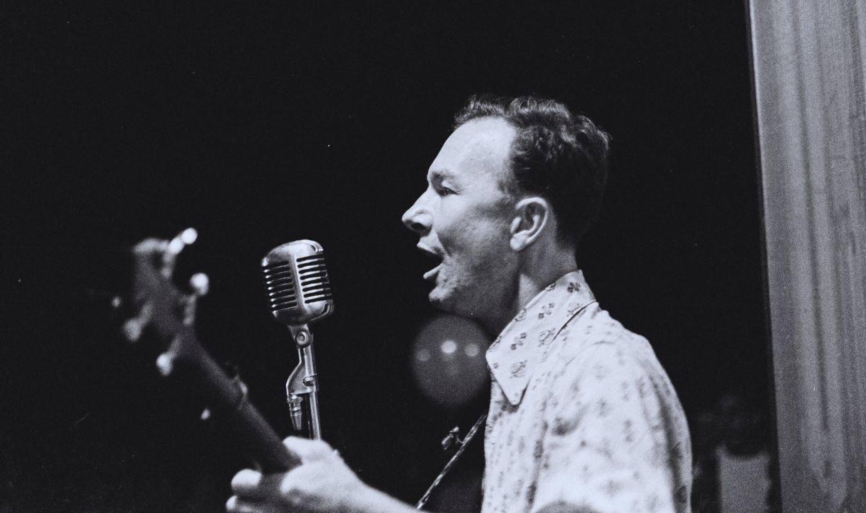 Gettyimages - 1396550321, Pete Seeger Performs At The World Peace Fair American folk musician Pete Seeger (1919 - 2014) plays an acoustic guitar as he performs onstage during the World Peace Fair, Fairless Hills, Pennsylvania, September 1960.