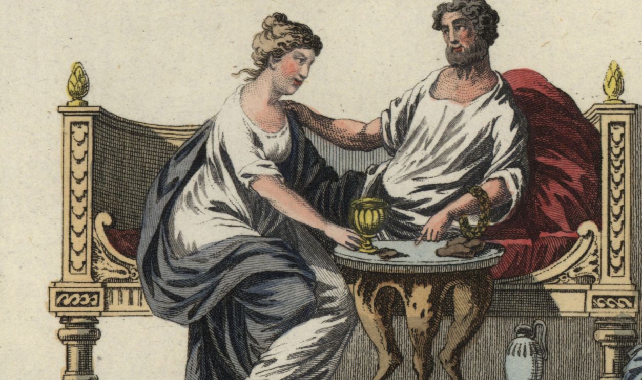 Roman married couple seated on a sofa in front of a three-legged table, while two slaves assist the patriarch to put on his slippers. Handcolored copperplate engraving from Robert von Spalart's 'Historical Picture of the Costumes of the Principal People of Antiquity and of the Middle Ages' (1798)