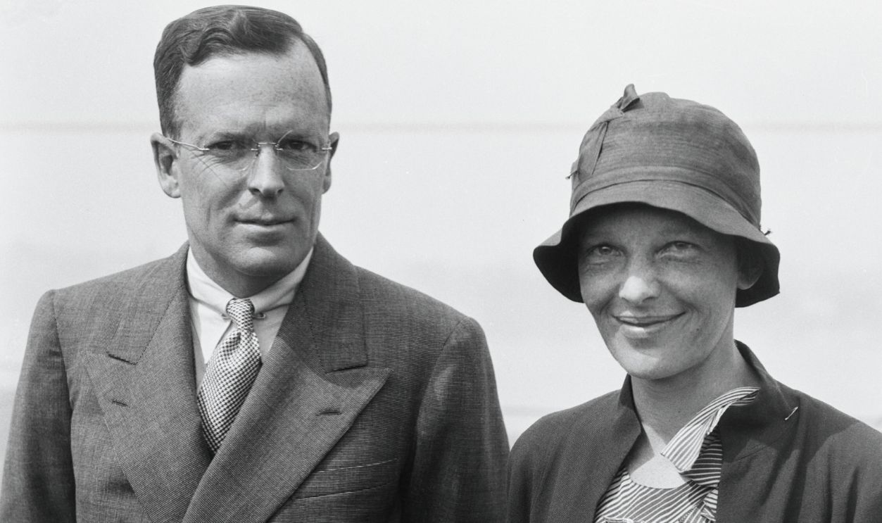 Accompanied by her husband, George P. Putnam, Mrs. Amelia Earhart Putnam is seen here aboard the tug Riverside, as she arrived on June 20th to receive the ovation and acclaim New York reserves for returning heroes and heroines. Lady Lindy's welcome started in the morning and will extend far into the night with banquets and fetes.