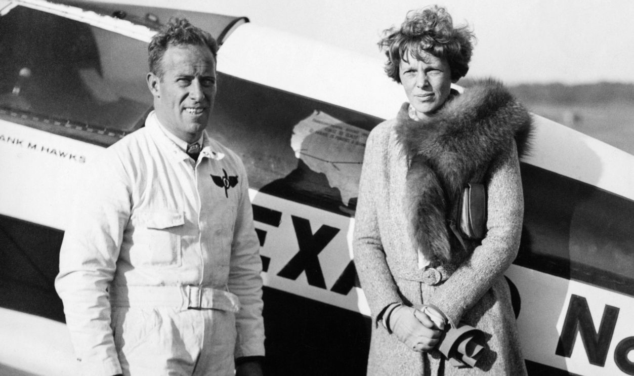 Amelia Earhart And Captain Frank Witness Air Tragedy At Trenton Races. Miss Amelia Earhart, first woman to fly across the Atlantic, with Captain Frank Hawks, holder of both transcontinental records, at the air races here where they watched two planes hit in midair and crash, killing both pilots. Captain Hawks was the pilot who gave Miss Earhart her first ride in a plane.