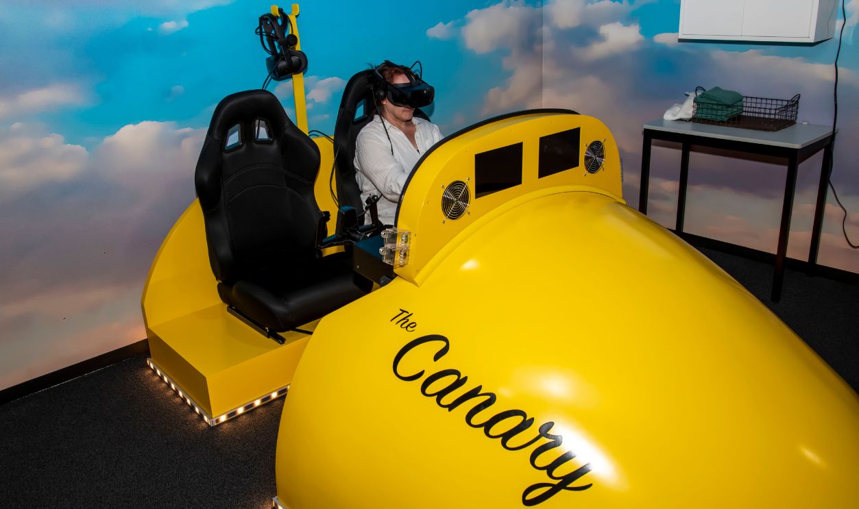 Atchison, Kansas. Amelia Earhart hangar museum. A woman enjoying the virtual reality flight to Paris. A virtual reality simulation of Amelia's transatlantic flight.