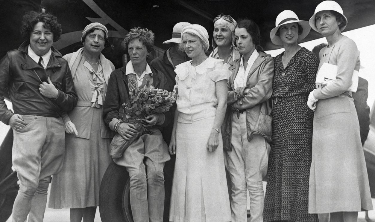 Skyladies Welcome Amelia. this group of famous women flyers was on hand to welcome Mrs. Amelia Earhart Putnam on her arrival at the United Airport in Burbank, California, her first visit to the coast since her transatlantic flight. Left to Right: Mrs. Florence Lowe Barnes, Mrs. Ulysses Grant McQueen, founder of the Women's International Association of Aeronautics; Mrs. Amelia Earhart Putnam, Mrs. Elizabeth Inwood, Janet Roberts, Mildred Morgan, Valentine Serague, Gladys O'Donnell, and Celma Granger.
