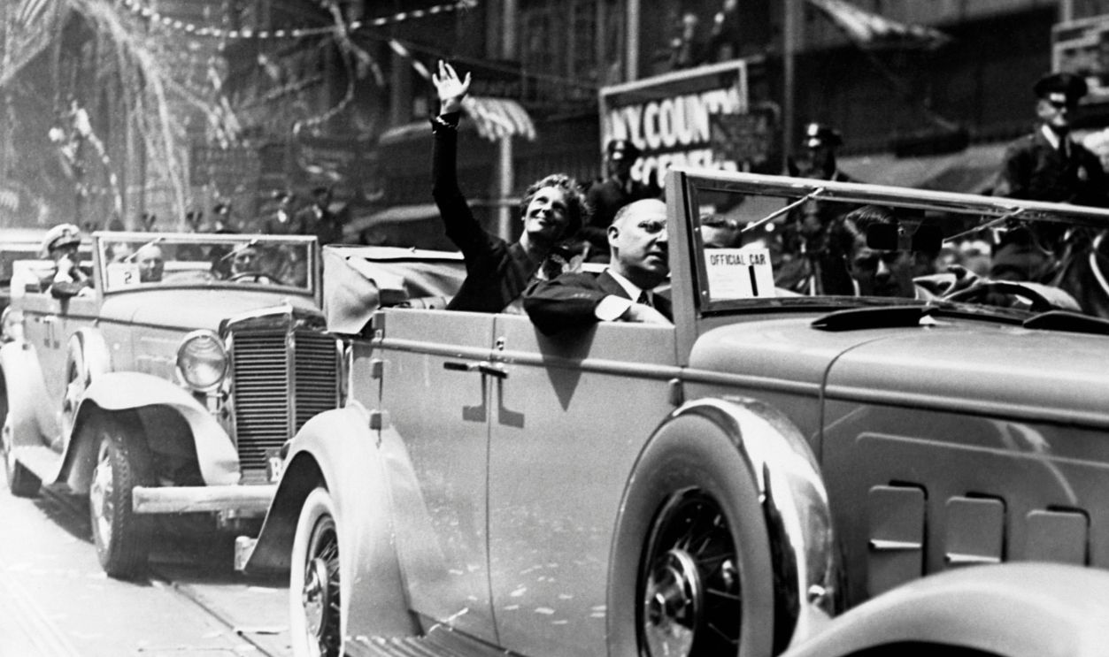 Amelia Earhart waves to New Yorkers from her car during the ticker-tape parade in her honor in June 1932, after her solo flight across the Atlantic on May 20-21. She was the first woman to make the flight alone.