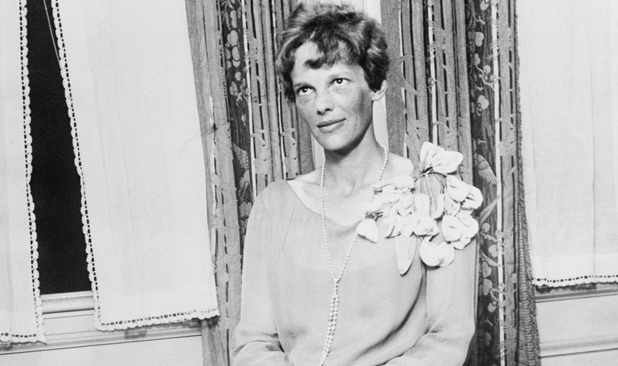 Aviation's Hall of Fame is well represented at the National Aeronautical Exposition, Mines Field, Los Angeles. Miss Amelia Earhart, flying her tiny Avro Avian English plane, arrived at the Glendale Airport, two weeks from the time she started from New York. Miss Earhart said she will be in daily attendance at the Air Meet but does not plan to participate in any of the events. She laughingly remarked that she didn't have nerve enough to land at Mines Field amid the swarm of planes there. Photo shows Miss Amelia Earhart shortly after her arrival at Los Angeles.