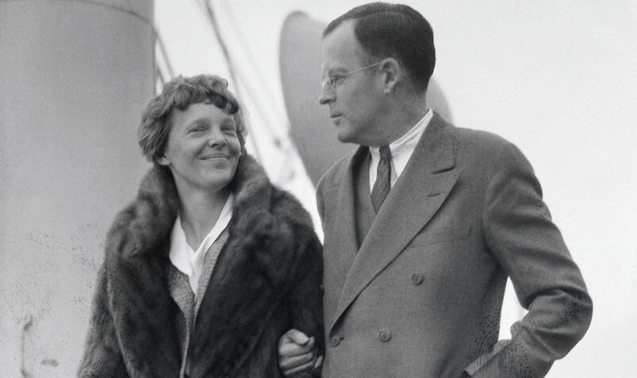 The American Aviatrix, Amelia Earhart is shown with her husband George Palmer Putnam on the deck of a ship.
