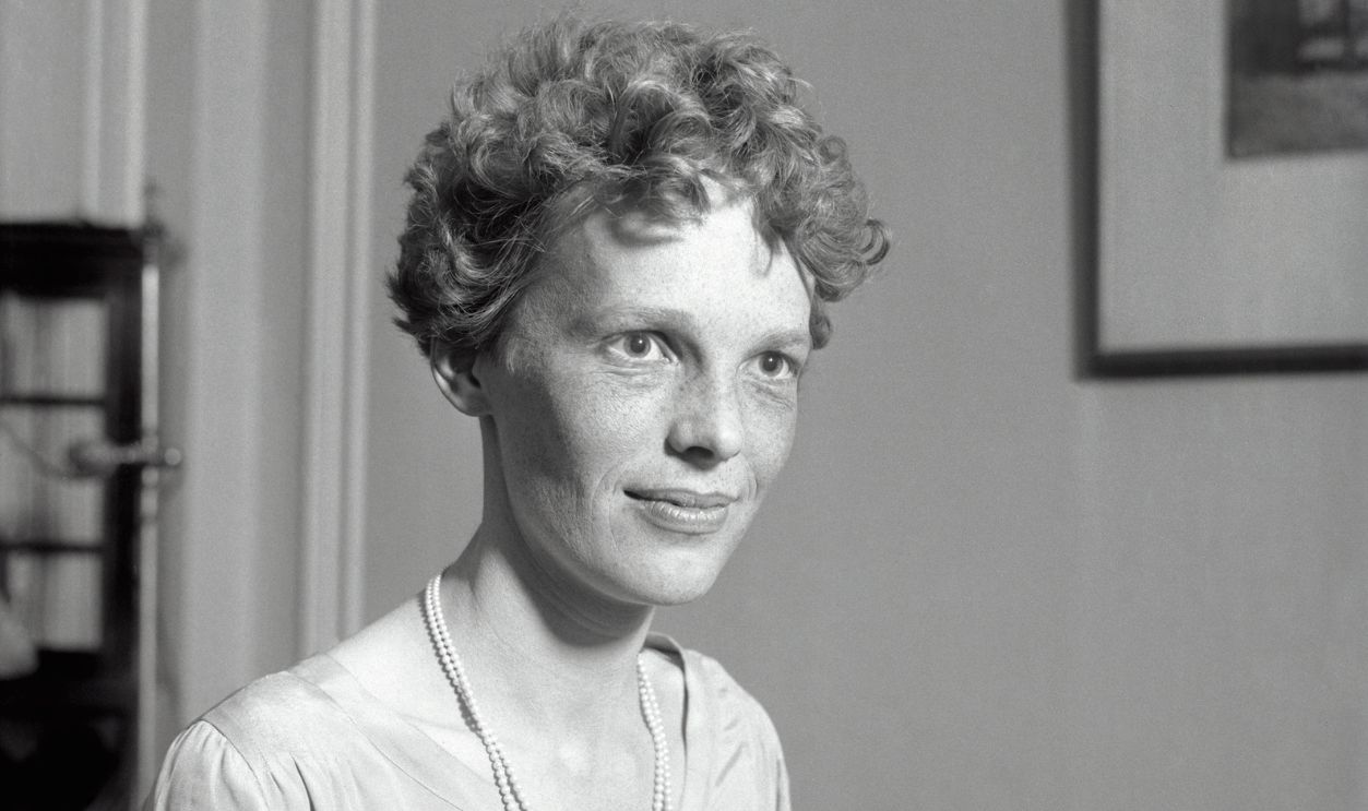 Amelia Earhart, first woman to fly across the Atlantic, is shown in a waist-up portrait.