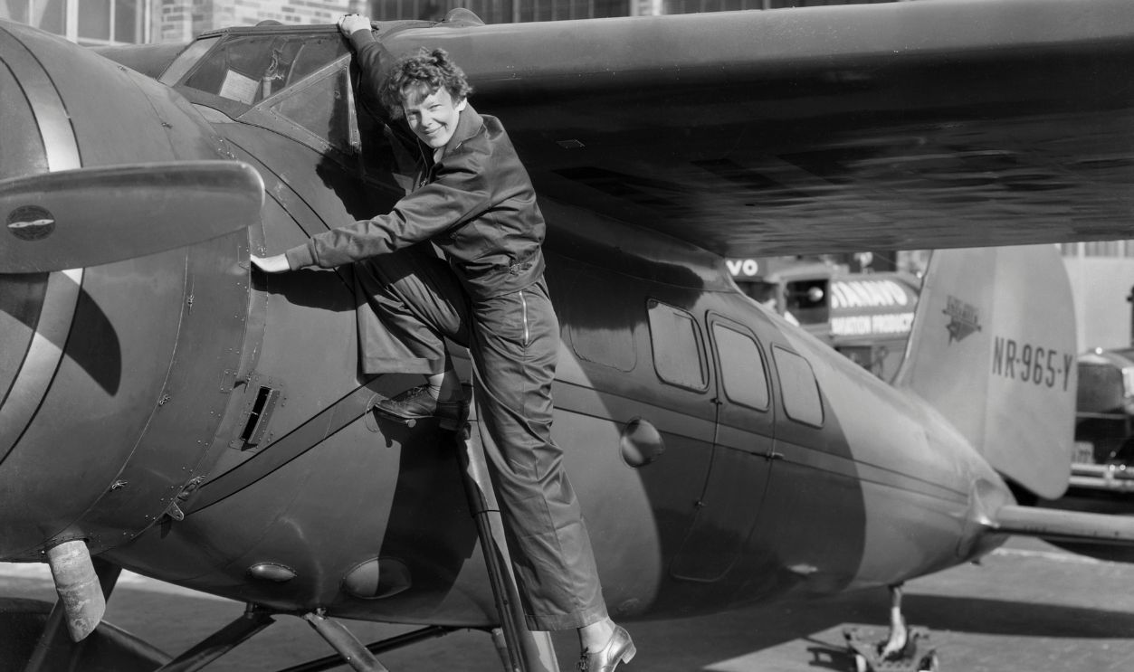 Amelia Earhart, (1898-1937), first woman to cross the Atlantic Ocean in an airplane. She is shown climbing into the cockpit. Undated photograph.