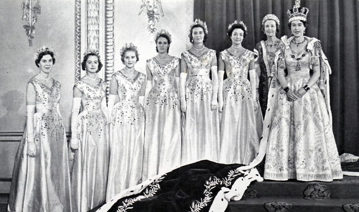 Queen Elizabeth II with her Mistress of the Robes and the six Maids of Honour after her coronation. 1953.
