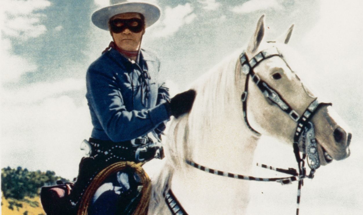 Clayton Moore rides a horse in movie art for the film The Lone Ranger, 1956.