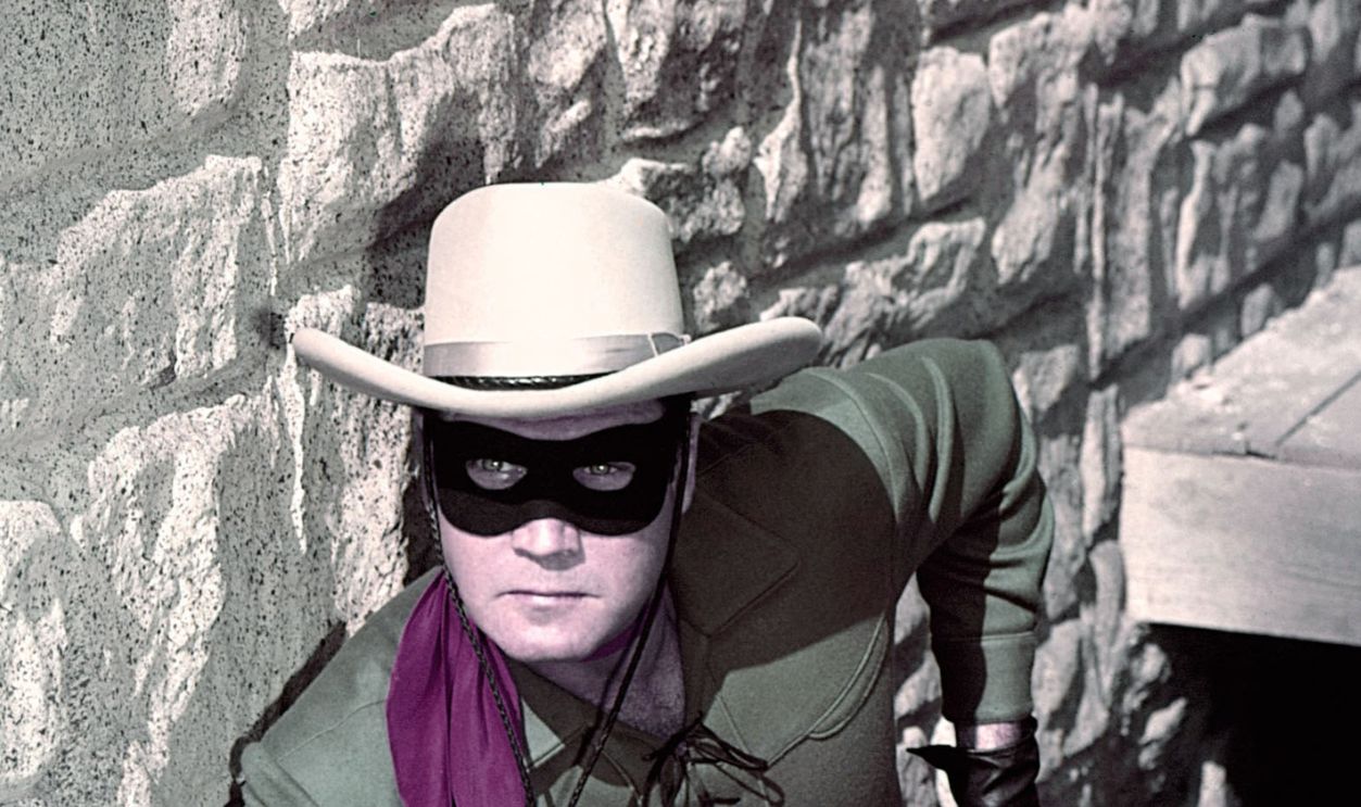 Clayton Moore (19141999), US actor, holding a handgun in a publicity still issued for the television series, 'The Lone Ranger', USA, circa 1950. The adventure series starred Moore as 'The Lone Ranger'.