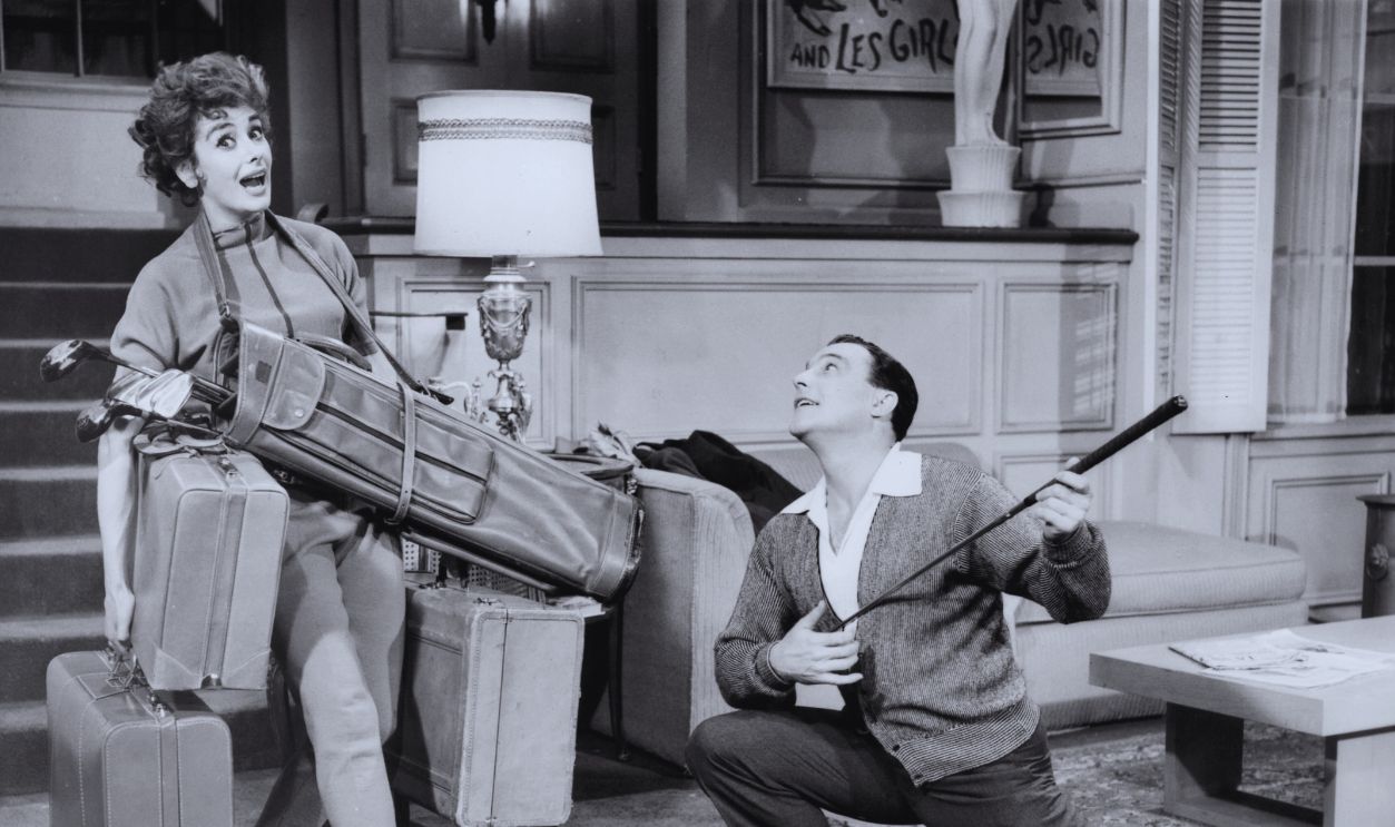 Gettyimages - 147965138, Kay Kendall And Gene Kelly In 'Les Girls' Kay Kendall carrying golf bag and luggage as Gene Kelly kneels before her in a scene from the film 'Les Girls', 1957.