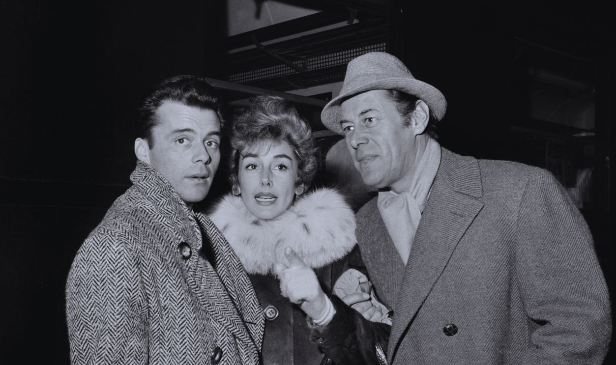 Gettyimages - 2192557660, Dirk Bogarde, Kay Kendall, Rex Harrison, 1957 Actor Dirk Bogarde, left, with actress Kay Kendall and her husband, actor Rex Harrison, December 10th 1957.