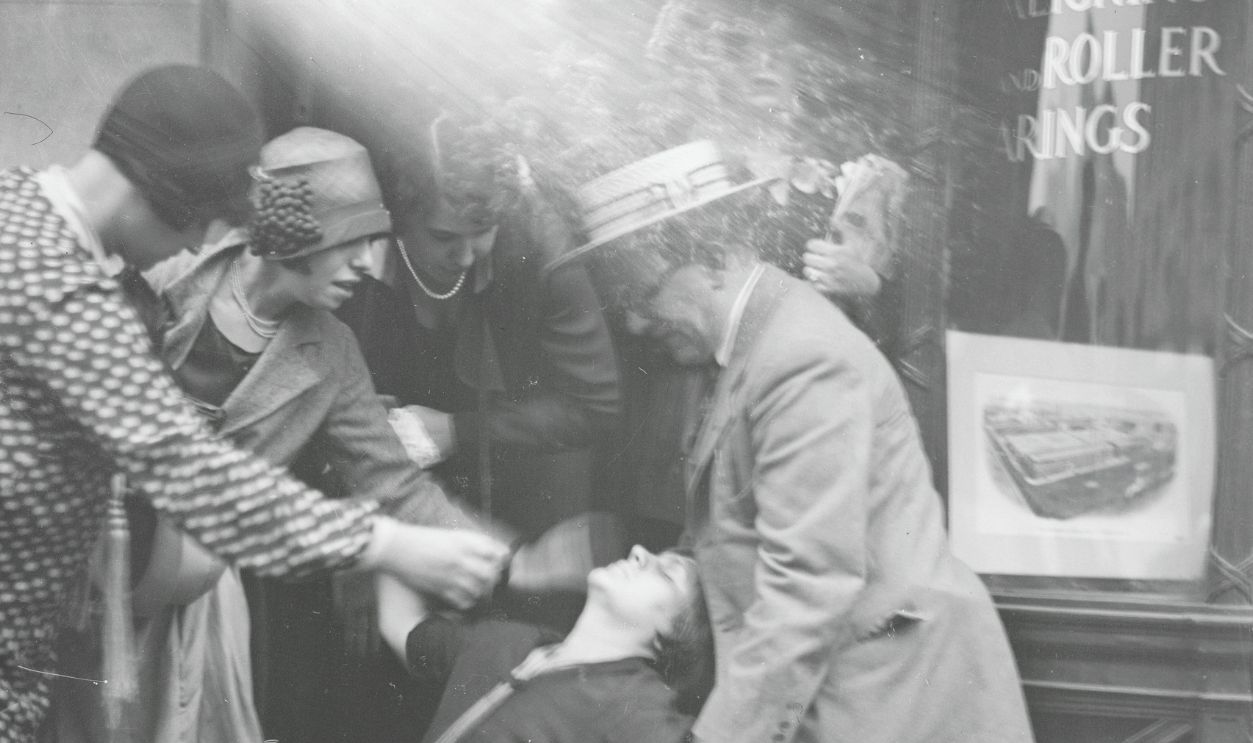 Gettyimages - 516015824, Onlookers Overseeing Overcome Woman (Original Caption) New York: Unidentified woman is helped to her feet after fainting outside