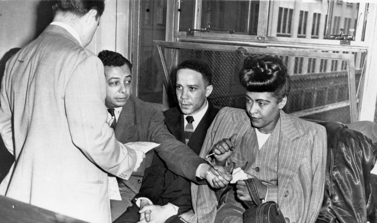 Jazz singer Billie Holiday (R) is read the charge for heroin possession at the U.S. Commissioners Office, seated next to her are her pianist Bobby Tucker (C) and road manager James Asendio (R) on May, 20, 1947 in Philadelphia, Pennsylvania. 