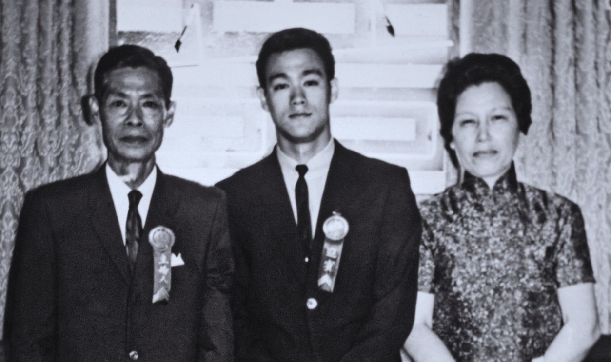 Gettyimages - 77344831, Bruce Lee And Parents KOWLOON, HONG KONG - CIRCA LATE 1950's: Bruce Lee along with his mother and father pose for a family snapshot circa the late 1950's in Kowloon Hong Kong.