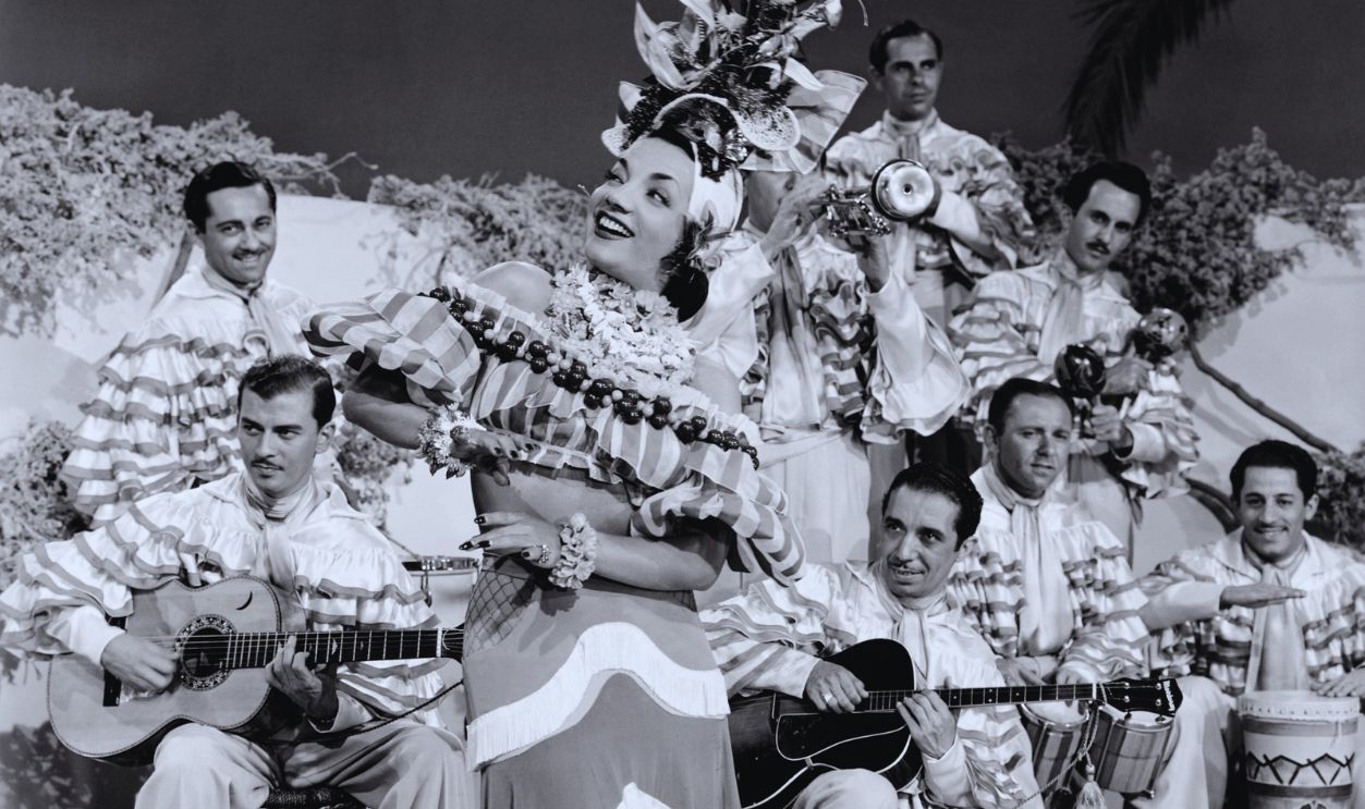 Gettyimages - 526879804, Carmen Miranda in Week-End in Havana Carmen Miranda, in the role of Rosita Rivas, dances to the music of a band in the 1941 film Week-End in Havana. 