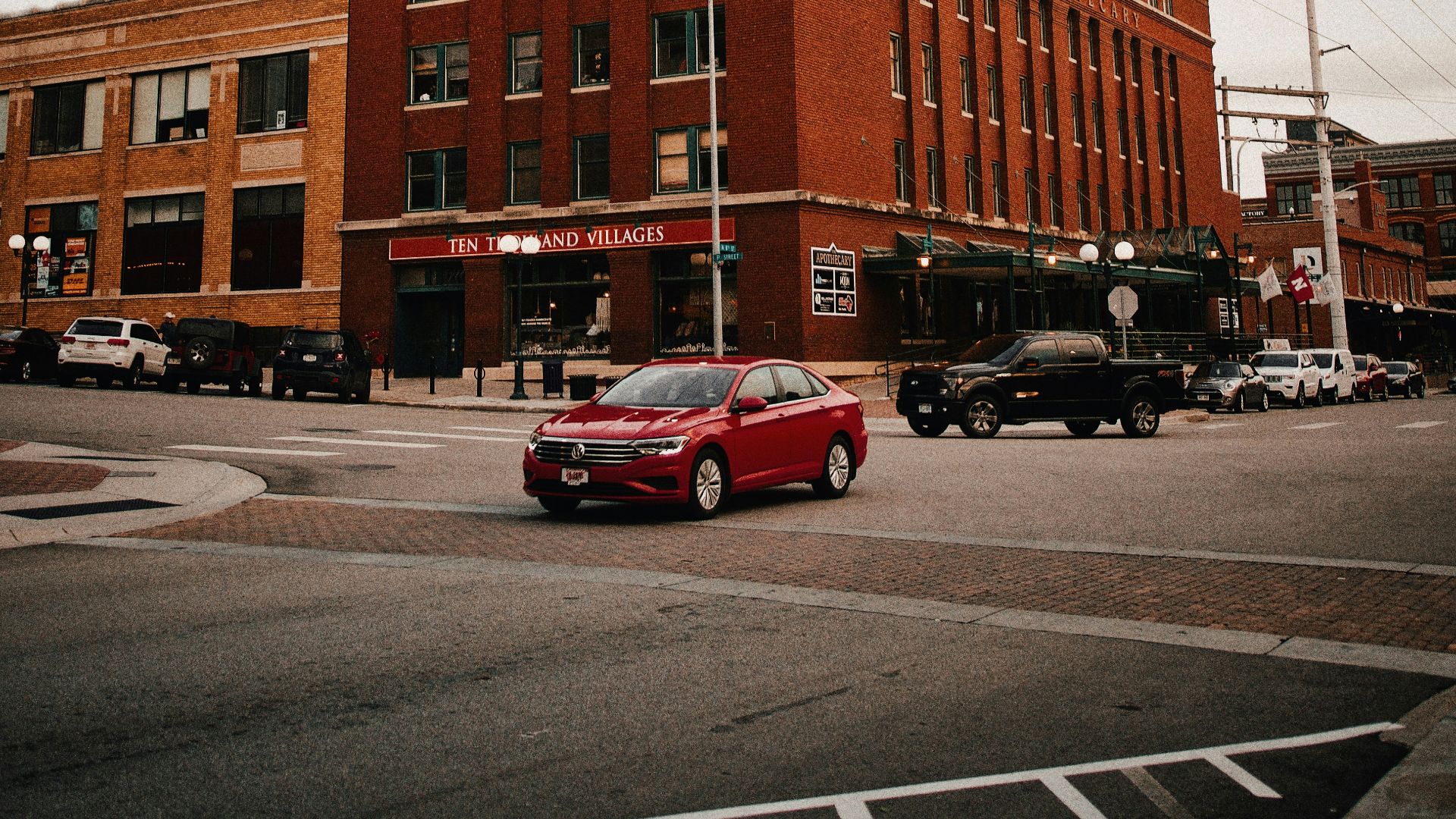 red sedan on road during daytime
