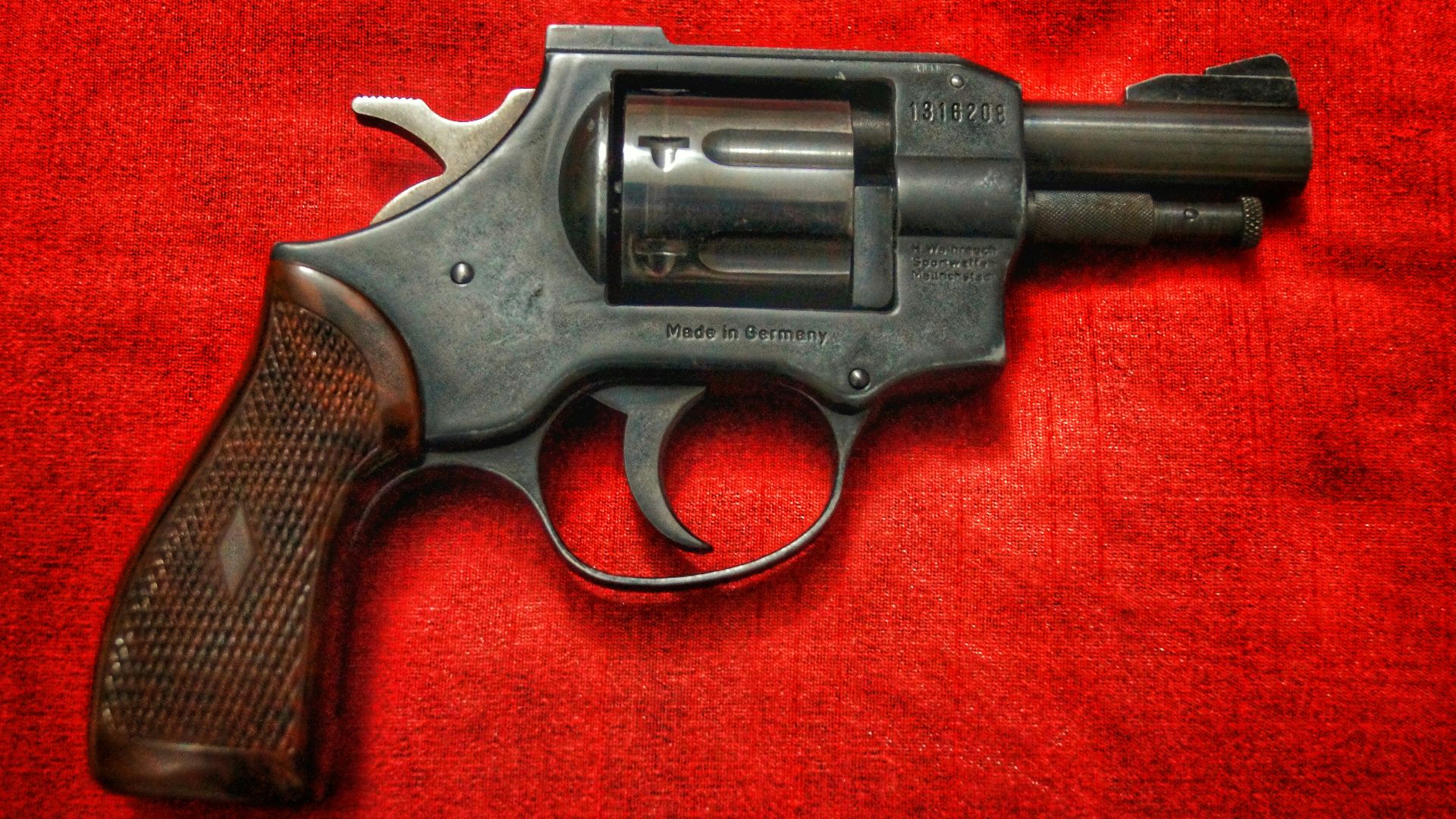 black and silver revolver on red textile