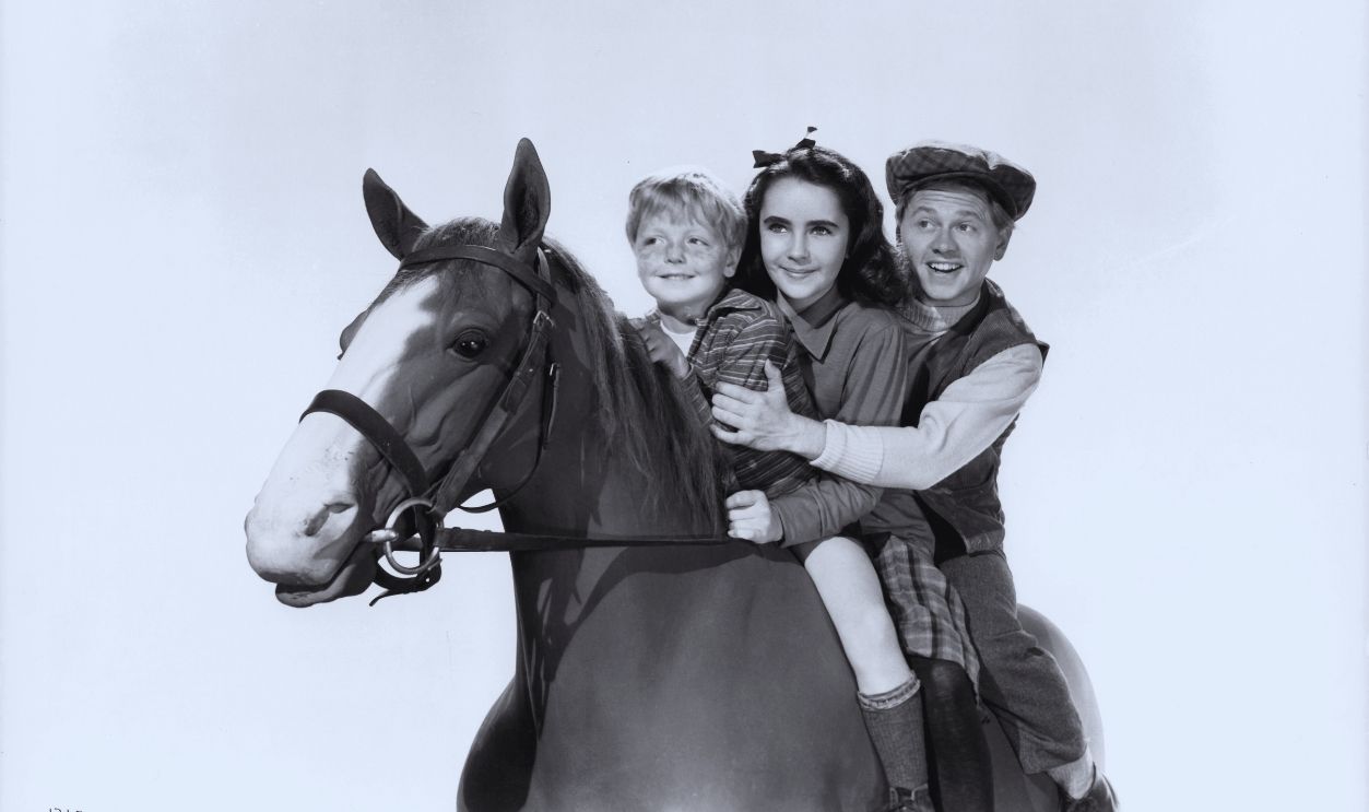 Gettyimages - 137395342, Elizabeth Taylor And Mickey Rooney In 'National Velvet' Jackie Jenkins, Elizabeth Taylor, and Mickey Rooney riding horseback in a scene from the film 'National Velvet', 1944.