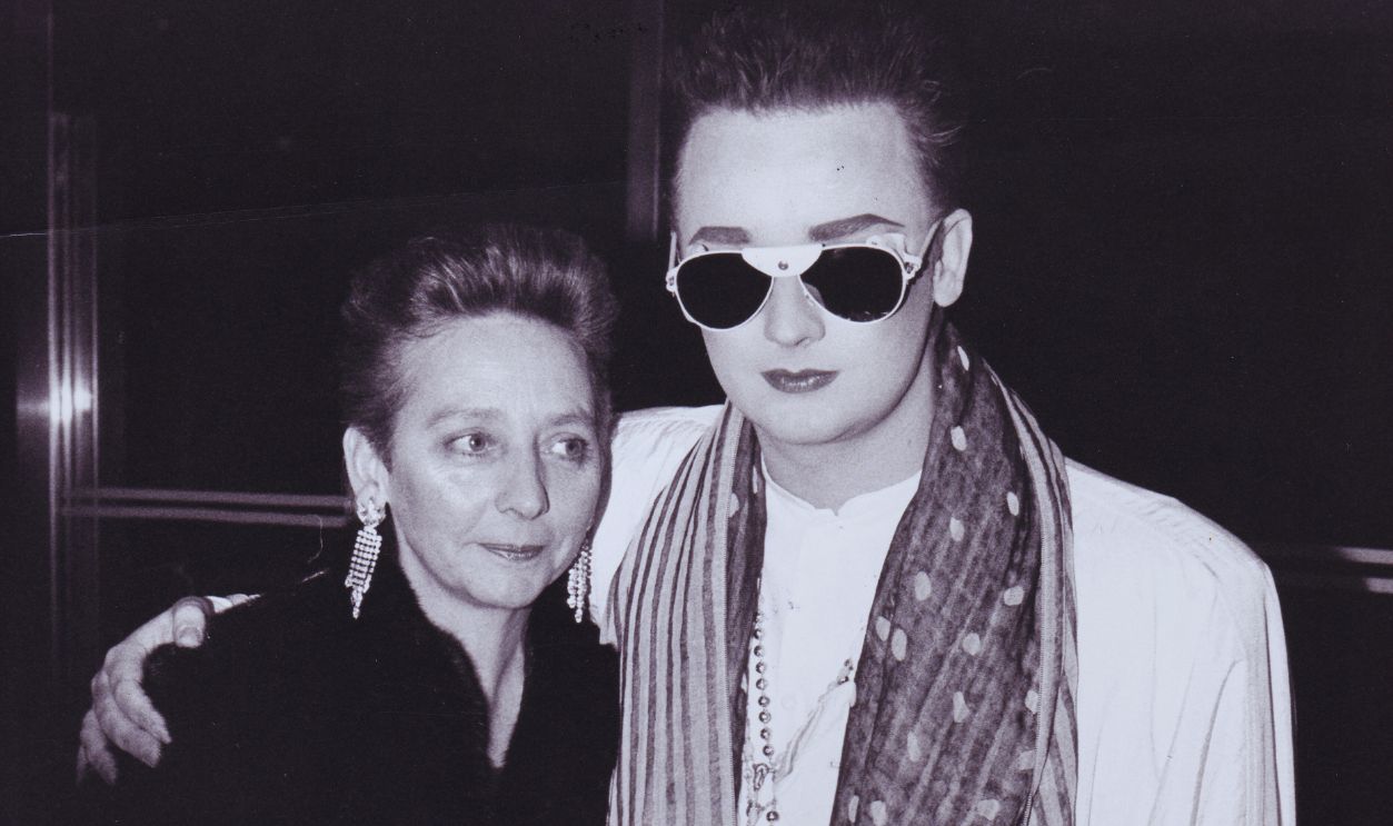 Gettyimages - 1329670749, Boy George and Mother Dinah O'Dowd In London, 1985 LONDON, ENGLAND - FEBRUARY 19: Singer Boy George (R) and his mother Dinah O'Dowd at Roof Gardens Party Kensington on February 19, 1985 in London, England.