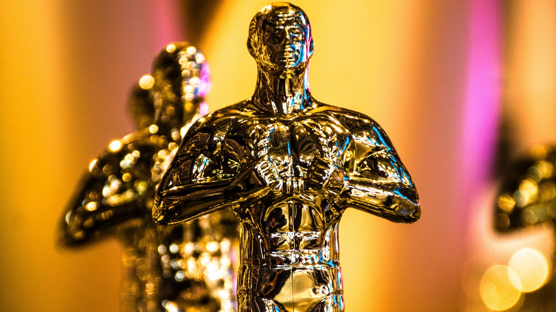 a number of oscar statues on a table