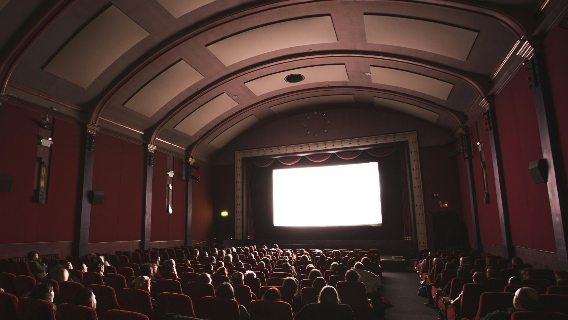 group of people staring at monitor inside room