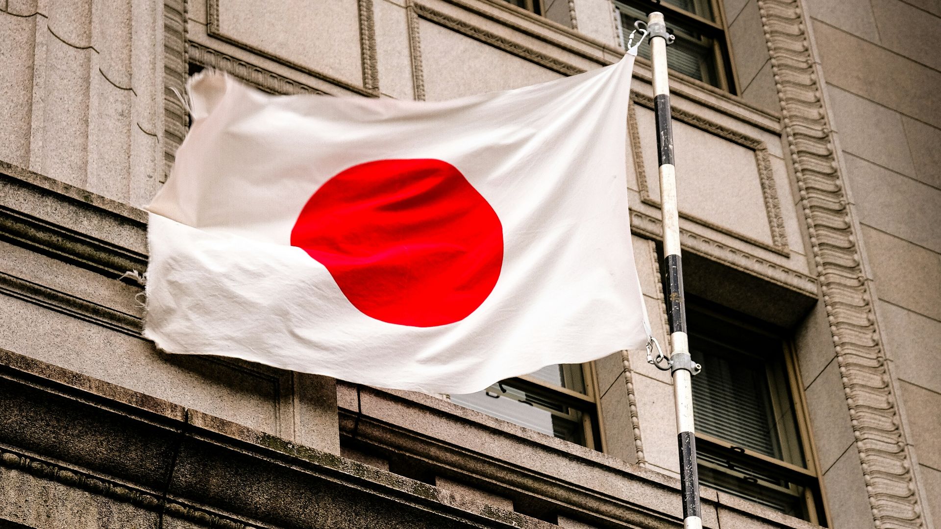 a flag flying in front of a building