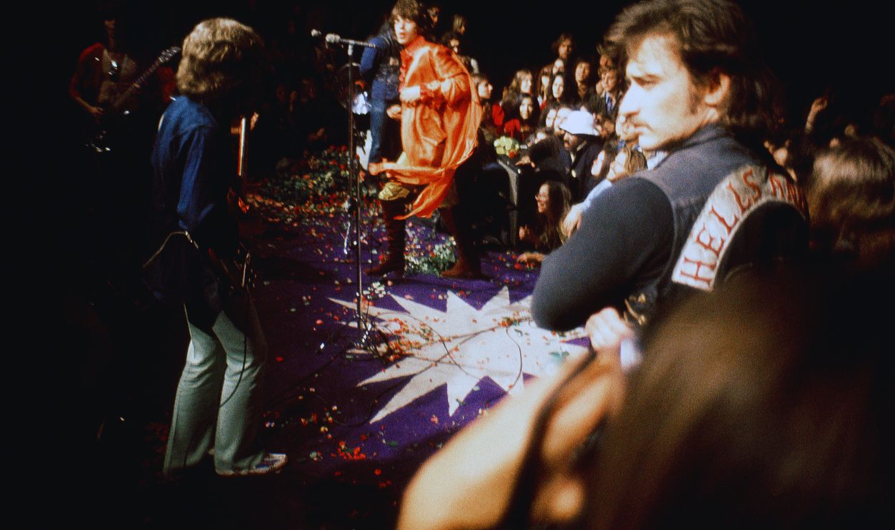 Gettyimages - 1318455238, The Rolling Stones and Hells Angels MC at Altamont TRACY, CA - DECEMBER 6: (L-R) English guitarist Mick Taylor, English singer, songwriter, actor, and film producer Mick Jagger and English guitarist, singer, and songwriter Keith Richards of the English rock band The Rolling Stones perform as Hell's Angels guard