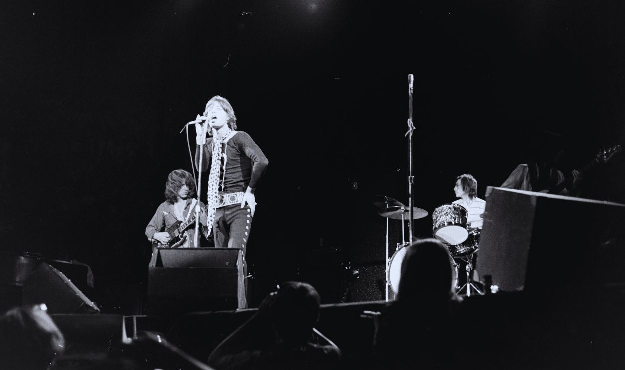 Gettyimages - 1439334386, The Rolling Stones Concert and Street Fashion at The Forum, Los Angeles 1969 Mick Taylor, Mick Jagger and Charlie Watts perform onstage during The Rolling Stones concert at The Forum, on Nov 8th 1969 in Los Angeles, CA.