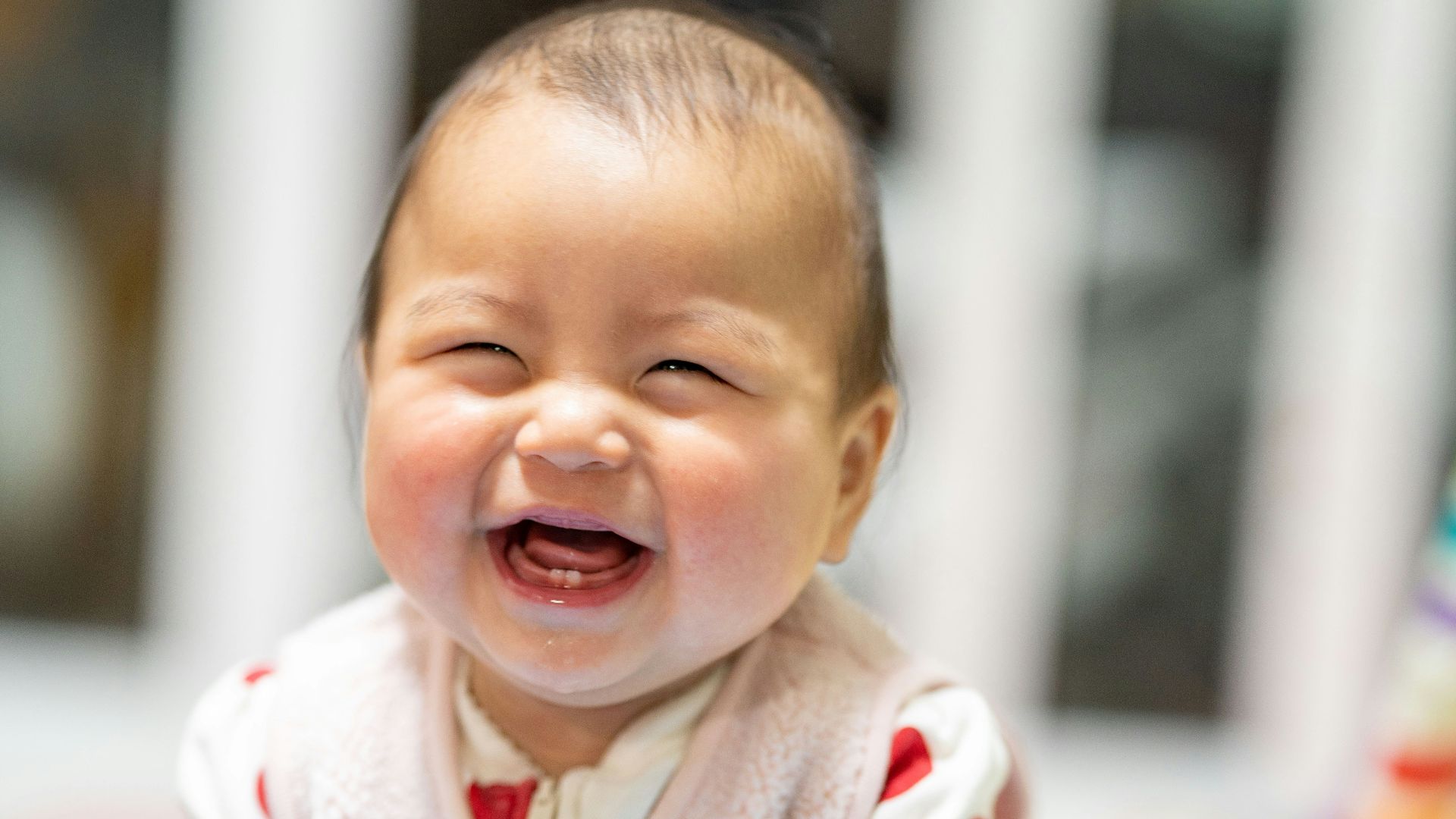 baby in white and red heart print onesie