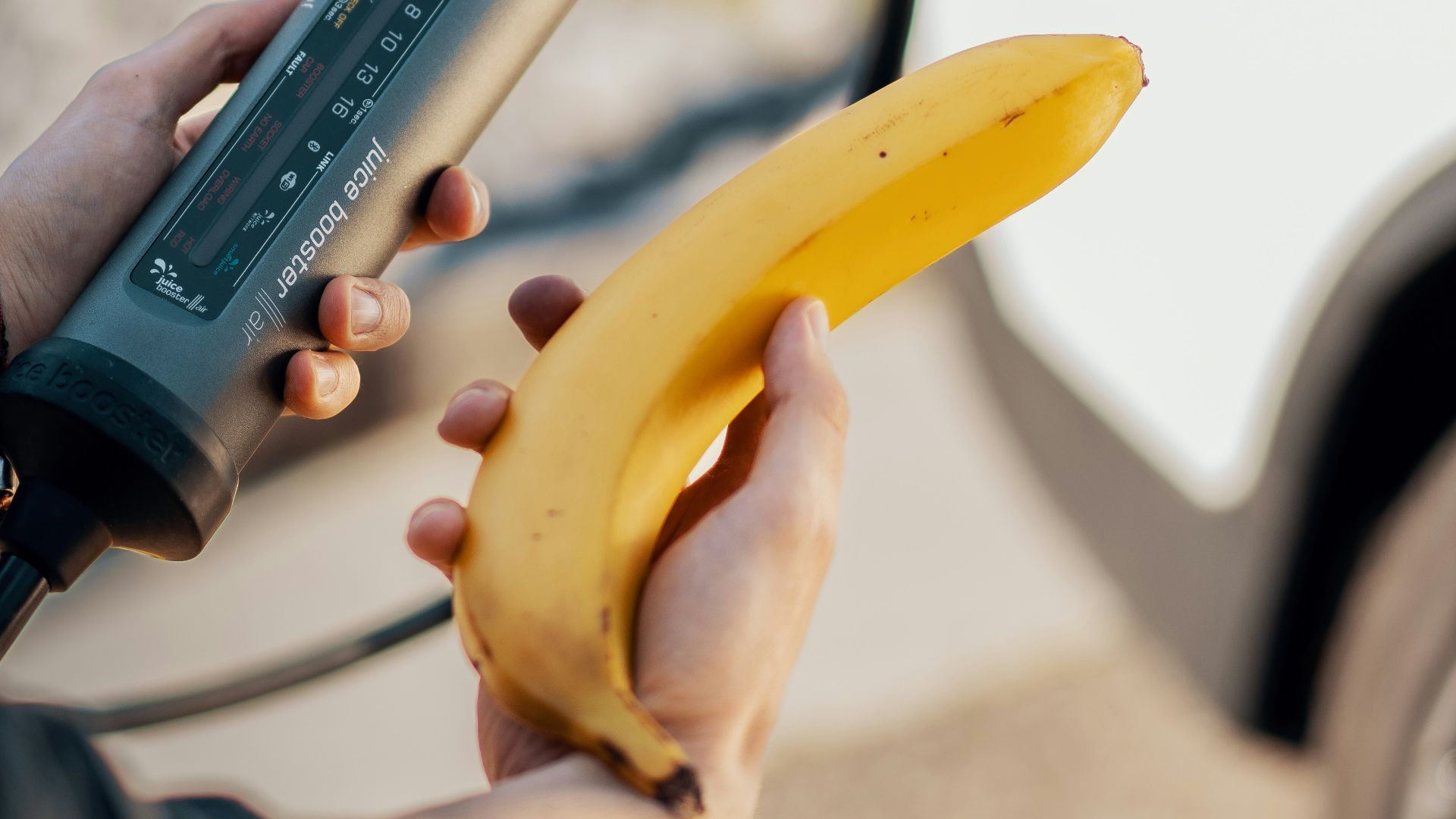 A person is holding a banana in their hand