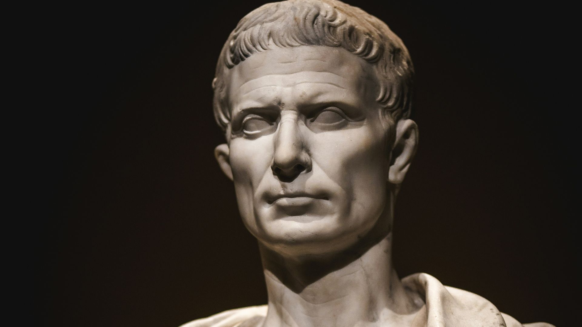 A bust of a man with a cape around his neck