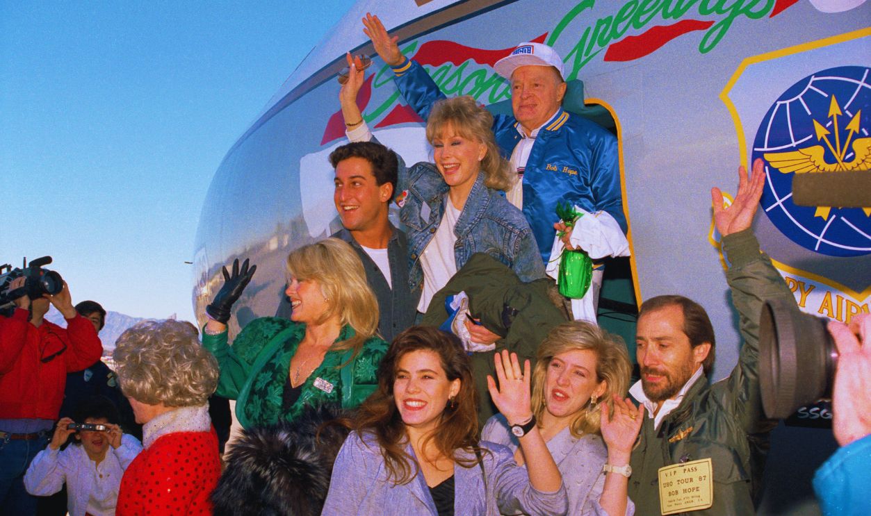 Gettyimages - 515322908, Bob Hope with Entertainers (Original Caption) Los Angeles: Bob Hope is back on the road as he leads a group of entertainers for his Bob Hope's Christmas Special from the Persian Gulf-Around the World in 8 Days which got off the ground. 