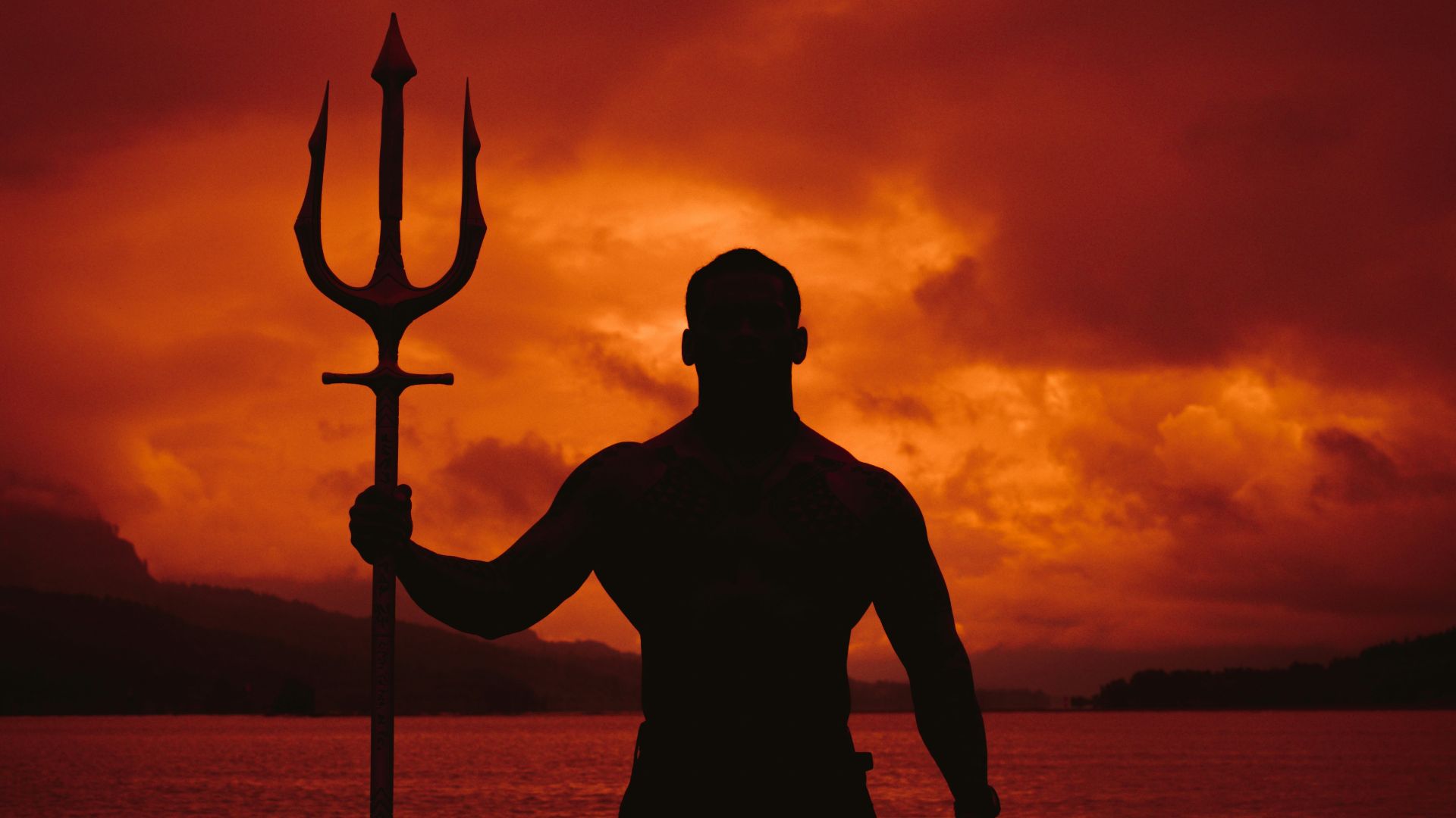 a man standing in the water with a pole in his hand