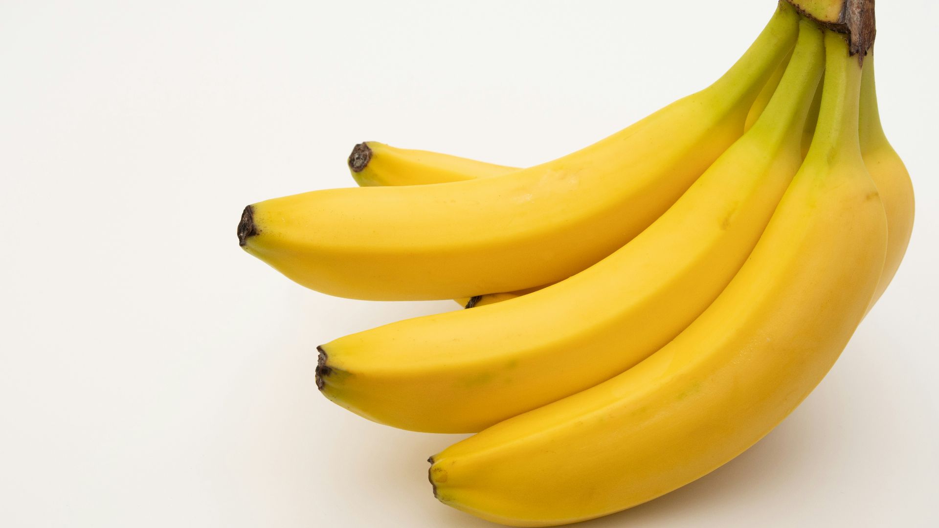 a bunch of bananas sitting on top of a white table