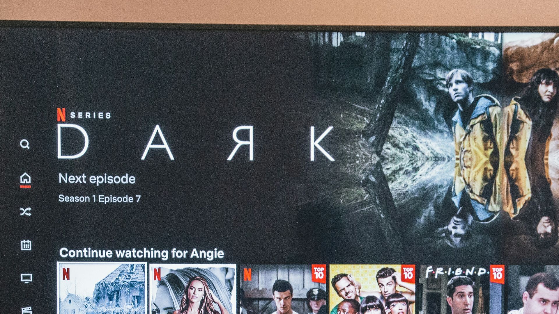 black flat screen tv turned on displaying man in black suit