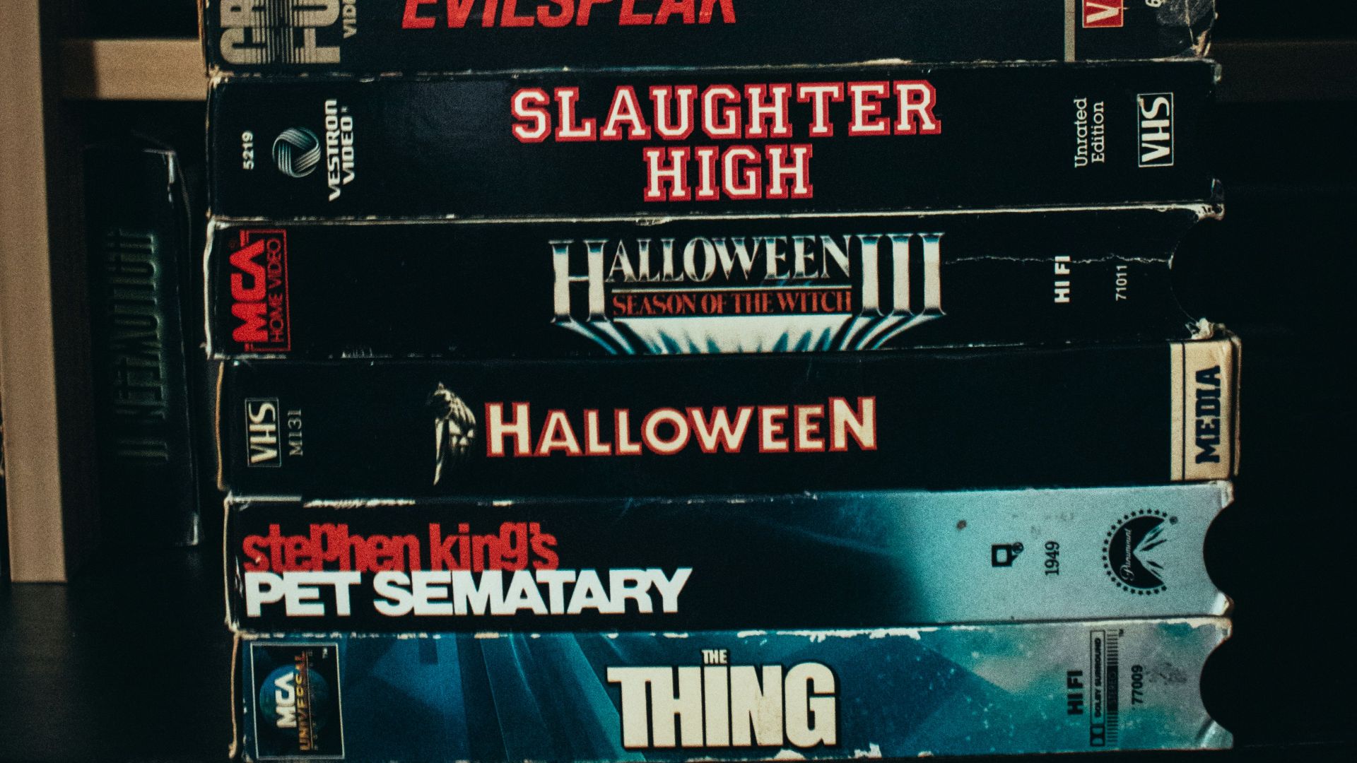 a stack of movies sitting on top of a shelf