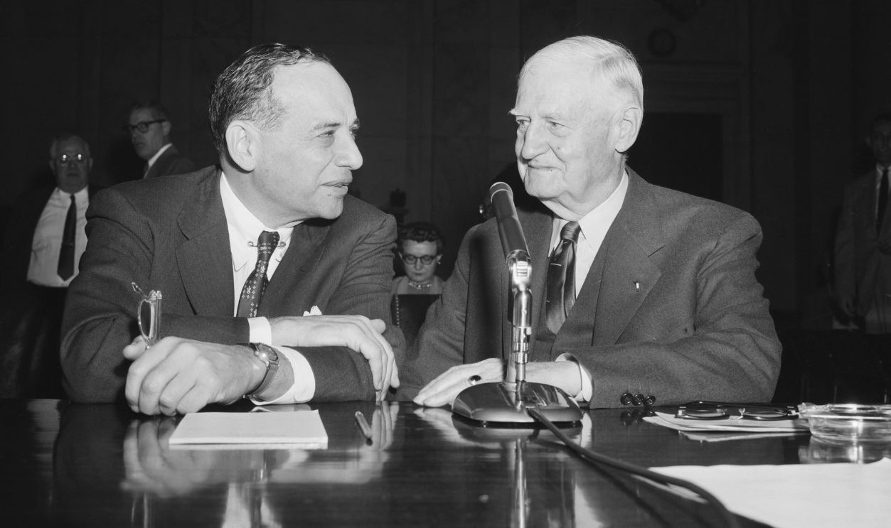 Graham and Woods testify before the Senate Banking Committee in Washington, DC. They are discussing the stock market and investing.