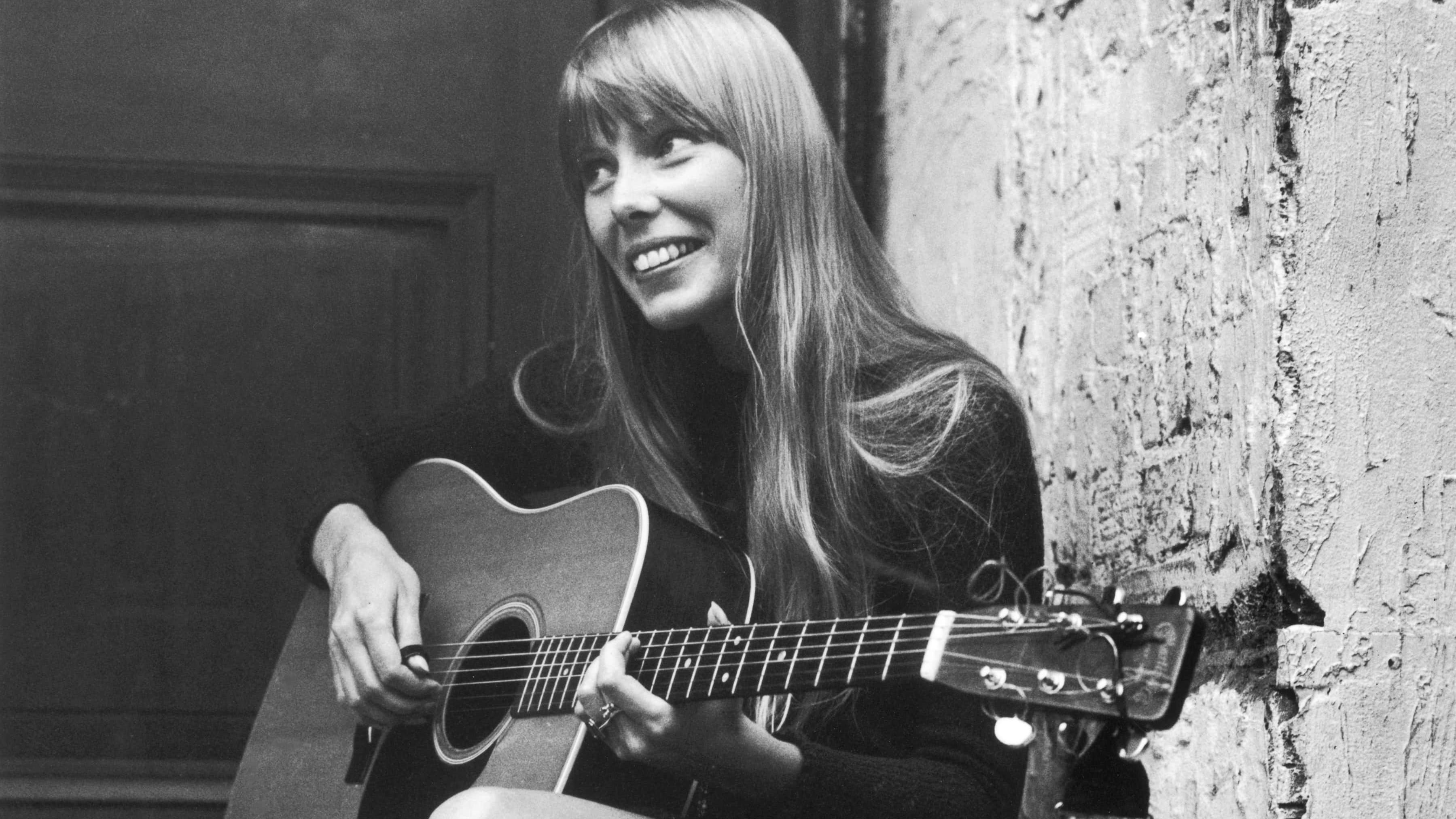 Joni Mitchell playing guitar
