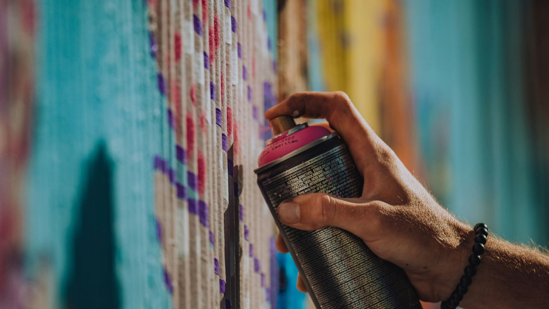 person holding black and red can