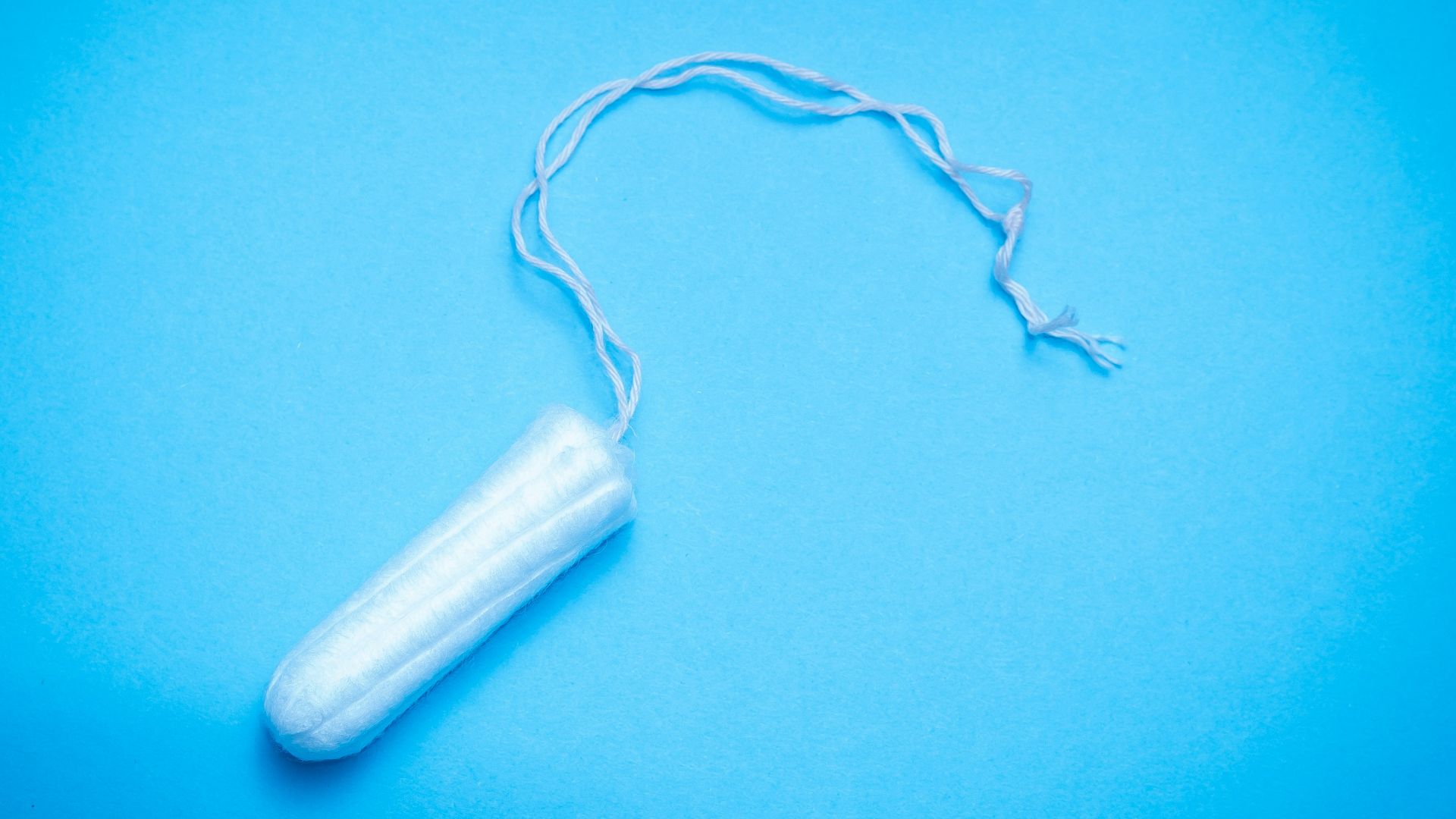 a plastic tube of toothpaste on a blue background