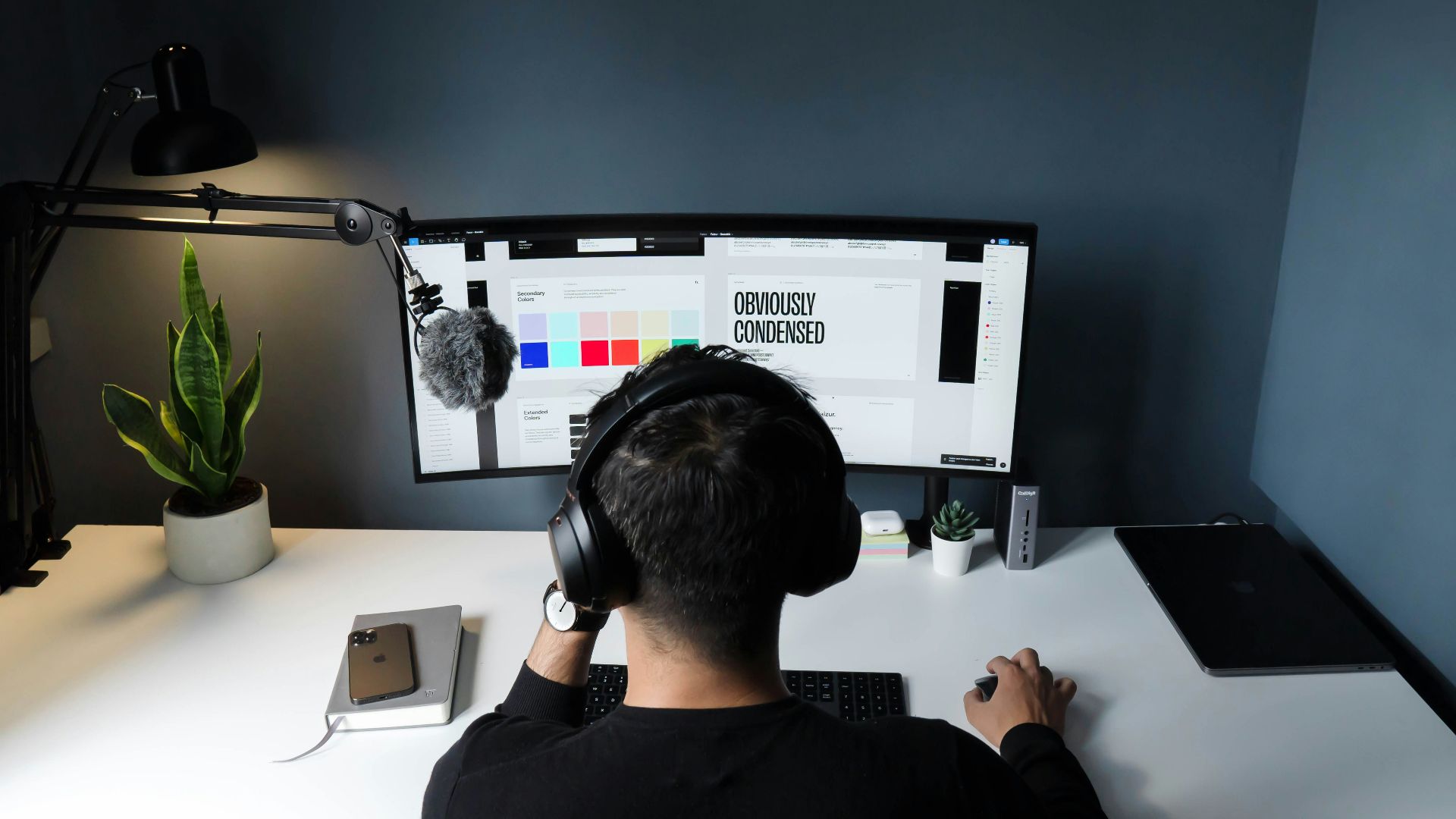 man in black shirt sitting in front of computer