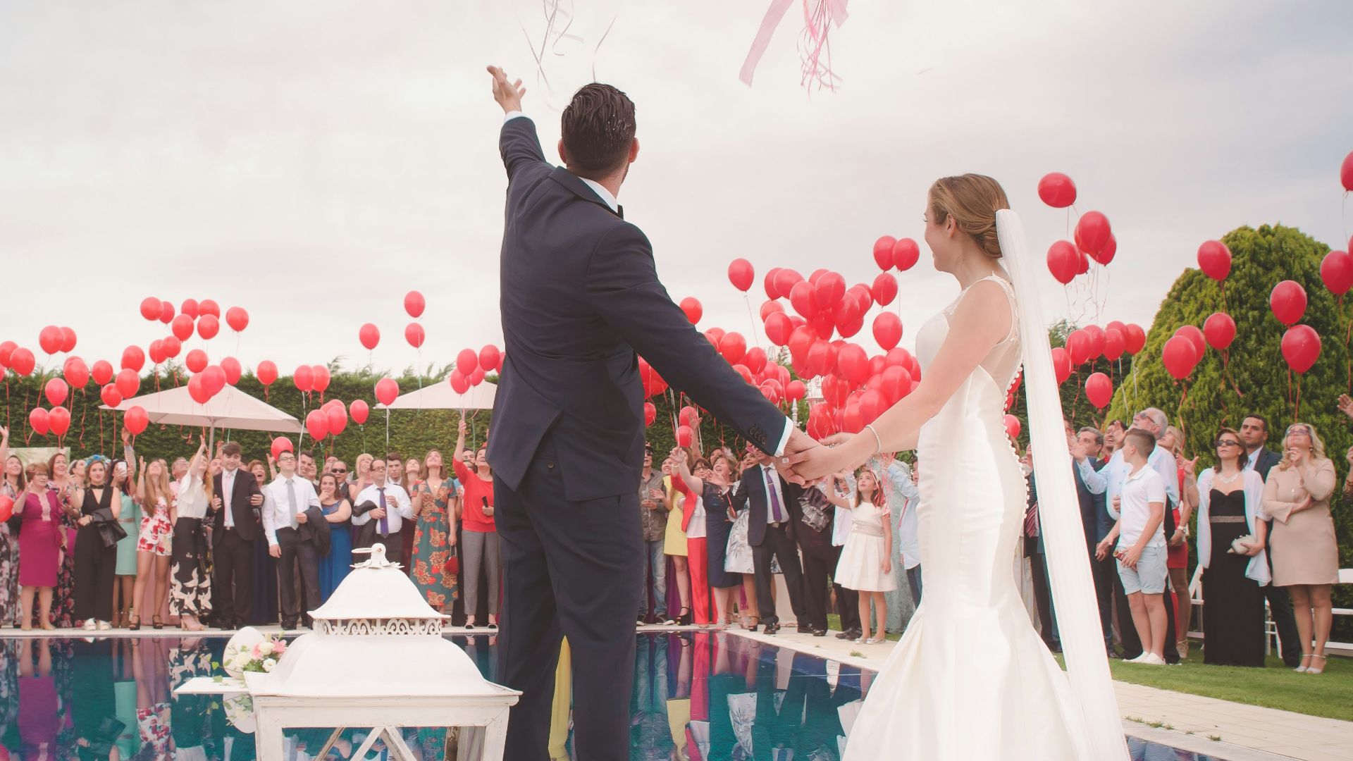 photo of a man and woman newly wedding holding a balloons